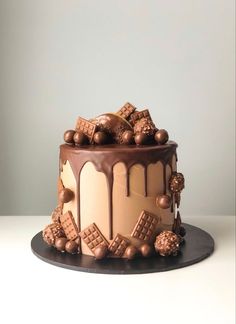 a cake with chocolate icing and nuts on top