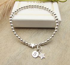 Sterling silver beaded stretch bracelet with a star and initial charm. Makes s a lovely gift for someone. Your Bracelet Details: - 925 sterling silver beads - sterling silver star bead - sterling silver initial charm The beads are 4mm. Finished on strong elastic thread " one size " which will fit up to 7 inches. Select your initial at checkout. Your bracelet will arrive in a gift box, and bow. A design by Silver Aurora Studio. Thank you. * Please read shop policy before ordering * Items in the U Star-shaped Letter Beads Bracelets As Gift, Star-shaped Letter Beads Bracelets For Gift, Star-shaped Letter Beads Bracelet As Gift, Star Shaped Letter Beads Bracelets For Gifts, Silver Beaded Bracelets With Star Charm, Silver Beaded Bracelet With Star Charm And Round Beads, Silver Beaded Bracelets With Star Charm As Gift, Silver Beaded Bracelet With Star Charm As Gift, Silver Beaded Bracelet With Star Charm For Gift