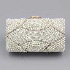 The Violeta Luxury Pearl Clutch Bag has a stunning and luxurious look. This bag is made of high-quality materials and has enough space for your essentials while still looking elegant at the same time. Its embroidered exterior bespeaks its beauty, while its exquisite frame demonstrates luxury. Exclusively available in c Luxury Clutch With Pearl Handle For Reception, Luxury Bags With Pearl Handle, Luxury Rectangular Bag With Pearl Handle, Luxury Bag With Pearl Handle, Rectangular Shape, Elegant White Rectangular Shoulder Bag, Beige Bag With Pearl Embroidery For Formal Occasions, Beige Clutch Bag With Pearl Embroidery, Luxury Beige Rectangular Clutch, Luxury Rectangular Cosmetic Bag For Formal Occasions