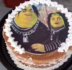 a cake with an image of two people on it and frosting around the edges