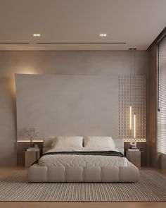 a large bed sitting in the middle of a bedroom next to a wall mounted lamp