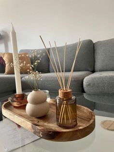 a living room with a couch, table and vases on top of the coffee table