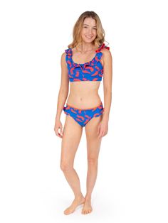 Double the Ruffle Fun with our matching Lola Bikini Bottom Make waves with our matching ruffle bikini bottom, designed to perfectly complement your Lola reversible ruffle bikini top! This flirty, feminine silhouette boasts the same playful ruffles, offering two chic patterns in one for endless mixing and matching possibilities. Dive into the details: Reversible design: Seamlessly switch between two vibrant patterns to match your mood and outfit. Fully reversible, two sided design. Flattering fit Vacation Swimwear With Ruffles And Tie-side Bottom, Beachy Ruffled Swimwear For Sunbathing, Beachy Ruffle Swimwear For Beach Parties, Beachy Ruffled Swimwear For Beach Party, Beachwear Swimwear With Ruffled Straps, Beachwear Tankini With Ruffles For Pool, Beachwear Swimwear With Ruffled Straps For Swimming, Ruffled Triangle Top Swimwear For Pool, Beach Swimwear With Ruffles And Tie-side Bottom