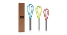 three colorful whisks are in front of a cardboard box