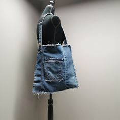 an old jean purse hanging on a hook