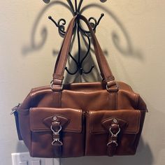 Like New! Nwot Cole Haan Super Soft Leather Nutmeg Brown Shoulder Bag Tote Purse W/Pockets. It Does Not Have The Long Shoulder Strap But Could Be Purchased From Cole Haan Separately. Bundle Discount: I Offer Everyone Who Buys A Bundle 20% Off! Just Bundle 2 Or More Items From My Closet And Poshmark Will Automatically Take Off 20%. Happy Shopping! Leather Satchel With Pockets For On-the-go, Brown On-the-go Shoulder Bag With Pockets, Double Handle Satchel With Pockets, Everyday Satchel With Multiple Pockets And Double Handle, Brown Shoulder Bag With Multiple Pockets, Brown Tote Bag With Multiple Pockets, Everyday Double Handle Satchel With Multiple Pockets, Brown Satchel With Multiple Pockets For Daily Use, Everyday Flap Bag With Multiple Pockets