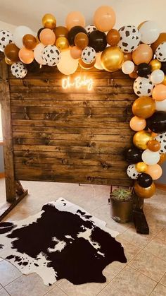 a room decorated with balloons and cowhides