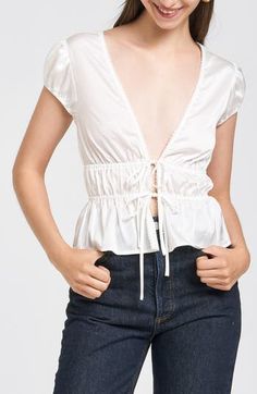 Dainty ties tether the front of this puff-sleeve top shaped by sweet smocking. Ties at front Deep V-neck Short sleeves 100% polyester Hand wash, dry flat Imported Tie Front Top, Front Tie Top, Puff Sleeve Top, V Neck Tops, Baby Sets, Deep V Neck, Jean Coat, Accessories Design, Designing Women