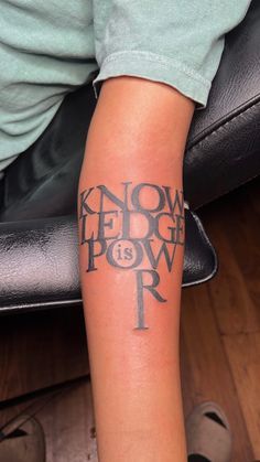 a person with a tattoo on their arm that says know what to do, power