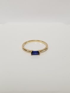 "Thanks for shopping our vintage estate store. We tend to sell well below wholesale and truly hope you enjoy all of our items. Many of the items are one of a kind, so please enjoy scrolling through the pictures and hopefully something will catch your eye. Brown spots are from reflections. Estate 14k yellow gold created .25ct sapphire ring.  Gem testing natural, but is created or synthetic.  Ring size: 7.75 Setting: 6.5mm 1/4\" by 3.5 1/8\" Band width: 1.5mm Weight: 1.71 grams Marked 14k and tested to be 14k gold." Classic Stackable Topaz Ring As Gift, Blue Stackable Rings With Emerald Cut, Blue Emerald Cut Stackable Rings, Classic Stackable Sapphire Jewelry, Sapphire Ring Stamped 14k As Gift, Classic Stackable Sapphire Ring As Gift, Classic Sapphire Stackable Jewelry, Blue Sapphire Ring Stamped 14k For Gift, Classic Stackable Sapphire Ring