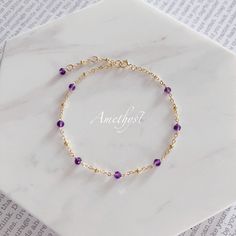 "* DETAILS* This dainty bracelet is a perfect gift to the one you love or to yourself. A nice every day bracelet. - Deep Purple Amethyst Faceted Beads 3mm - 24k Gold Filled Chain - 14K Gold Filled Wire - 14k Gold Filled Spring Ring Clasp 5mm Bracelet has a 1\" Extension with amethyst bead charm. ✨All components are gold filled. 👉🏻For more birthstone bracelets, see https://www.etsy.com/shop/JinnysJewelryBySeJin 🌟You may also like Blue Topaz Bracelet. Here is the link. https://www.etsy.com/Jinn Topaz Bracelet, Carnelian Bracelet, Blue Topaz Bracelet, Turquoise Pendant Necklace, Emerald Bracelet, Birthday Gift For Women, Emerald Bead, Birthstone Bracelet, Dainty Bracelet