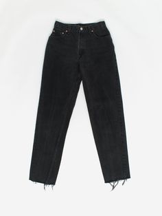 Vintage Levis 550 women's jeans 27 x 31 black dark wash 90s. These classic 550s feature a relaxed fit, tapered leg, zipper fly, distressed hems, rear patch and Levis red tab on the back pocket. Made for women, circa 1990. The original label states L, 8 REG. They measure 27 X 31. Condition: Very good; raw edge, frayed hems  Measurements, laid flat, in inches:  Waist: 13.5 Inside leg: 31 Front rise: 11.25 Hip (measured across the bottom of the fly): 19 Thigh (measured from crotch seam to outside o Black Tapered Leg Jeans For Fall, Black Rigid Denim Bottoms For Spring, Black Jeans Standard Cut For Fall, Black Standard Cut Jeans For Fall, Classic Black Jeans With Relaxed Fit, Classic High Rise Black Jeans, 90s Style Washed Black Straight Leg Bottoms, Black Rigid Denim Pants For Fall, Classic Black Relaxed Fit Jeans