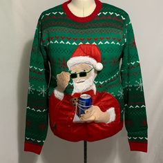 a green and red sweater with santa clause holding a cup