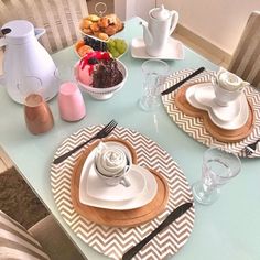 a table set with plates, cups and saucers