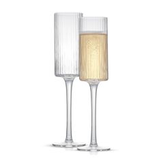 two champagne flutes are next to each other