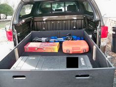 the back end of a pickup truck with tools in it's bed and toolbox