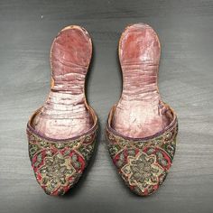 Item Details.A pair of women’s antique Indian embroidered slippers which are from Bengal in the 1800’s. I bought them in Delhi in the 1980’s and they have been in my collection since. The uppers on this pair are fashioned in silk velvets in jewel colours of magenta and emerald green. They are encrusted with silver gilt embroidery, some of which is raised and padded, depicting stylised floral motifs. Edged in a narrow purple ribbon, these slippers are so lovely! Measurements.10 inch (25 cm) toe t Traditional Closed Toe Mules For Festive Occasions, Traditional Closed Toe Mules For Festivals, Traditional Pointed Toe Mules, Slippers Embroidered, Traditional Formal Slip-on Slippers, Traditional Embroidered Closed Toe Mules, Traditional Embroidered Round Toe Slippers, Regency Slippers, Traditional Embroidered Mules