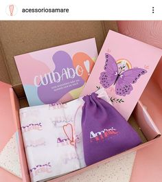 a pink box with two greeting cards and a drawstring bag in it that says curado