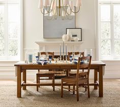 a dining room table with chairs and a chandelier