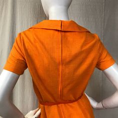 "This is a lovely short sleeve dress in a bright cheery tangerine. There's a zipper (19\") down the back with hooks at the top for the collar. The sleeves are short. There are two pockets at the waist. The belt is included. Details Size: unmarked, fits a modern 4 - 6 Bust: 36\" Sleeve length: 7\" Shoulder: 14.5\" Waist: 32\" Hips: 36\" Length: 41\" Belt: 26\" - 31\" Label: unmarked Colors: Tangerine Condition: Excellent, no issues." Vintage Orange Knee-length Dress, Retro Orange Lined Dress, Fitted Orange Mod Dress, Orange Fitted Mod Dress, Orange Mod Fitted Dress, Mod Style, Dress Short Sleeve, Mod Fashion, Mod Dress