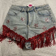 Mainstrip Denim Shorts With Red Fringe! Called The Shake It Shorts, Never Worn, Nwt, Bought From An Online Boutique.Best Fits A Medium But Could Probably Also Fit A Small, Stretchy Material Trendy High Waist Jean Shorts For Parties, High Waist Bottoms With Frayed Hem For Festival, Trendy Medium Wash Festival Bottoms, Party Cutoff Denim Shorts, High Waist Denim Festival Shorts, High Rise Jean Shorts For Festival, Trendy Cutoff Bottoms For Party, Trendy Denim Blue Party Bottoms, Trendy Festival Bottoms With Frayed Hem