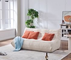 a living room filled with furniture and a white rug