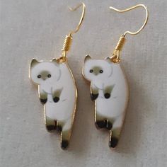 Dangling Cats Earring Cute Cat Design Dangle Earrings, Cute Cat Design Adjustable Earrings, Adjustable Cute Cat Design Earrings, Cute Adjustable Cat Design Earrings, Cute Cat Design Drop Earrings, Cat Design Metal Drop Earrings, Metal Cat Design Drop Earrings, Gold Metal Cat Design Earrings, White Cat Design Jewelry With Cat Ears