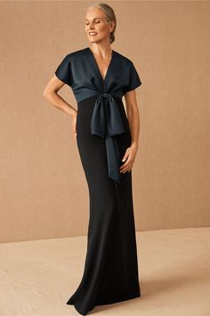 This elegant column gown features a beautifully draped satin bodice with a chic bow detail at the waist.Only available at BHLDN Sukienki Maksi, Formal Wedding Guests, Mother Of Bride Outfits, Mother Of The Bride Dresses Long, Mother Of Groom Dresses, Mob Dresses, Column Gown, Groom Wear, Groom Outfit