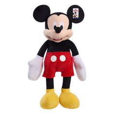 the mickey mouse stuffed animal is wearing red shorts