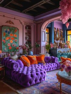 a living room filled with lots of purple furniture