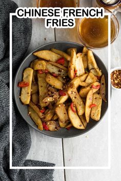 chinese french fries in a bowl next to two glasses of beer on a white table