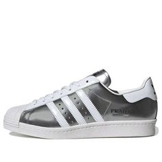 Adidas Superstar x Prada Shoes 'Silver White' FX4546 (SNKR) Modern Silver Sneakers With Metallic Logo, Silver Sneakers With Metallic Logo For Streetwear, Modern Silver Sneakers With Rubber Sole, Silver Custom Sneakers With Rubber Sole For Streetwear, Modern Silver Custom Sneakers For Sports, Custom Silver Sneakers With Rubber Sole For Streetwear, Luxury Silver Sneakers With Rubber Sole, Modern Silver Low-top Custom Sneakers, Silver Sneakers With Perforated Toe Box