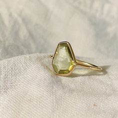 A unique ring featuring a  uniquely flat and faceted cut vivid peridot. The stone is see through, very interesting! The band is round, and 1.5mm wide, crafted in solid 18K yellow gold. Golden Beryl, Puffy Heart Charms, Tiny Charm, 18k Yellow Gold Ring, Green Peridot, Unique Ring, Yellow Gold Ring, Stackable Rings, Bright Green