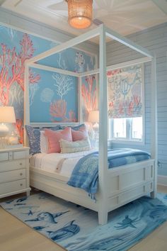 a bedroom with blue and white walls, corals on the wall and a canopy bed