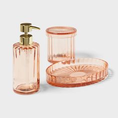 an orange glass bathroom set with soap dispenser