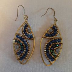 The Earrings Are Multi Strand Of Blue Micro Beads. The Ear Wires Are Gold Filled. The Length Is 2.5"S And The Width Is 1". They Are Quite Pretty On. They Were A Gift. New, Never Worn And In Excellent Condition. Blue Metal Beaded Earrings With Colorful Beads, Handmade Blue Beaded Metal Earrings, Blue Earrings With Colorful Metal Beads, Blue Metal Beaded Earrings, Blue Beaded Metal Earrings, Blue Metal Beaded Earrings Wire Wrapped, Blue Wire Wrapped Beaded Metal Earrings, Blue Wire Wrapped Beaded Earrings For Party, Party Blue Beaded Earrings With Gold Beads