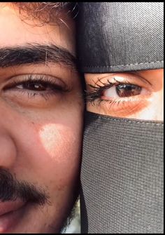 a man and woman are looking at the camera with their eyes close to each other