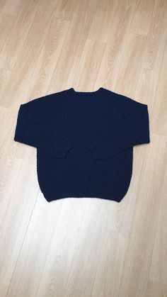 a blue sweater laying on the floor