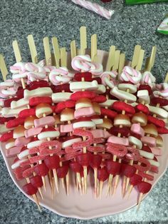 there are many skewers with candy on them