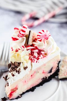 a slice of peppermint ice cream cake on a white plate with a fork