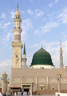 people are standing in front of a large building with a green dome on the top