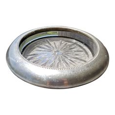 a metal tray with a circular design on the bottom and center piece in the middle