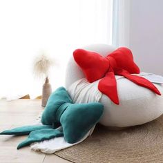 a white and red stuffed animal laying on top of a rug