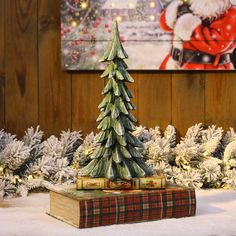 a small christmas tree sitting on top of a book