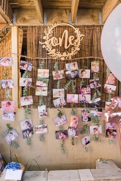 a wall with pictures and balloons hanging on it