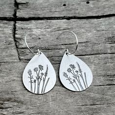 Ever imagine yourself running in a field of flowers or having a cute picnic there? Your love of simple beauty that comes from spring when flowers cover the hillsides or that lovely bouquet you get at the farmers markets. You can know have the flowers that will never die with these earrings featuring Indian Paintbrush, Wild Lupine, and Balsamroot. The wildflowers of the Rocky Mountains represent the gentle transition of seasons, from Winter to Spring, flowers are the signs of new beginnings and c Whimsical Spring Earrings With Flower Charm, Dainty Adjustable Flower Earrings For Spring, Whimsical Spring Earrings For Pierced Ears, Spring Flower Charm Jewelry, Whimsical Spring Earrings, Spring Dainty Dangle Earrings, Dainty Spring Dangle Earrings, Delicate Flower Earrings For Spring, Dainty Spring Flower Earrings For Pierced Ears