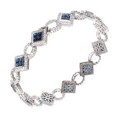 18k white gold blue sapphire and diamond bracelet. Underside safety. Sapphires are invisibly set with round accent diamonds. Hand piercing on the back where it does not show. Length: 7.5 inches 44 Square sapphires amount to 5.39ct total. 37 round diamonds 5.39ct total G VS. This is nice. Stamped: 18k. 19.7 grams. Length: 7.5 inches. Blue Sapphire Jewelry With Single-cut Diamonds, Blue Sapphire Jewelry With Single Cut Diamonds, Fine Jewelry With Sapphire And Single Cut Diamonds, Elegant Blue Topaz Bracelet, Luxury Sterling Silver Tennis Bracelet With Diamond Accents, Luxury Hand-set Sapphire Jewelry, Fine Jewelry Sapphire With Pave Setting, Fine Sapphire Jewelry With Pave Setting, Formal Sapphire Jewelry With Single Cut Diamonds