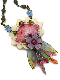 a necklace with flowers and beads hanging from it