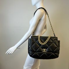 Chanel Maxi 19 Flap Bag with Bi-colored Chain Link Shoulder Strap, Interlocking CC Logo and Quilted Pattern (includes Dustbag) Designer = Chanel Color = Black Material = Lamb Skin Condition = Excellent Height = 10 Width = 14 Depth = 4.5" Class = Premier Location: Wilmette Item Number: 20201-73 Item ID: 300893 Category: Shoulder Bag Designer Tote Shoulder Bag With Cc Turnlock Closure, Evening Tote Shoulder Bag With Cc Turnlock Closure, Shopping Tote Shoulder Bag With Cc Turnlock Closure, High-end Shoulder Bag With Chain Strap For Travel, Luxury Chain Crossbody Bag, Designer Black Bag With Chain, Designer Black Flap Bag With Chain Strap, Top Handle Flap Bag With Chain Strap For Shopping, Designer Shoulder Bag With Chain For Travel