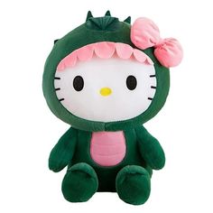 a green hello kitty stuffed animal with a pink bow on its head, sitting in front of a white background